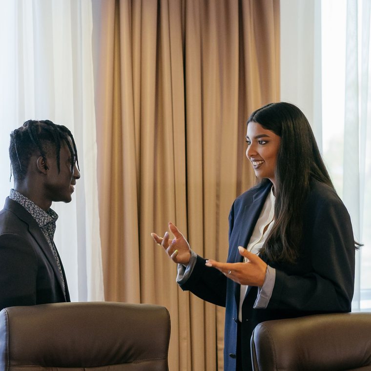 Two professionals in conversation, representing personal brand visibility and authority